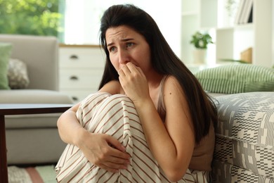 Photo of Woman suffering from panic attack at home