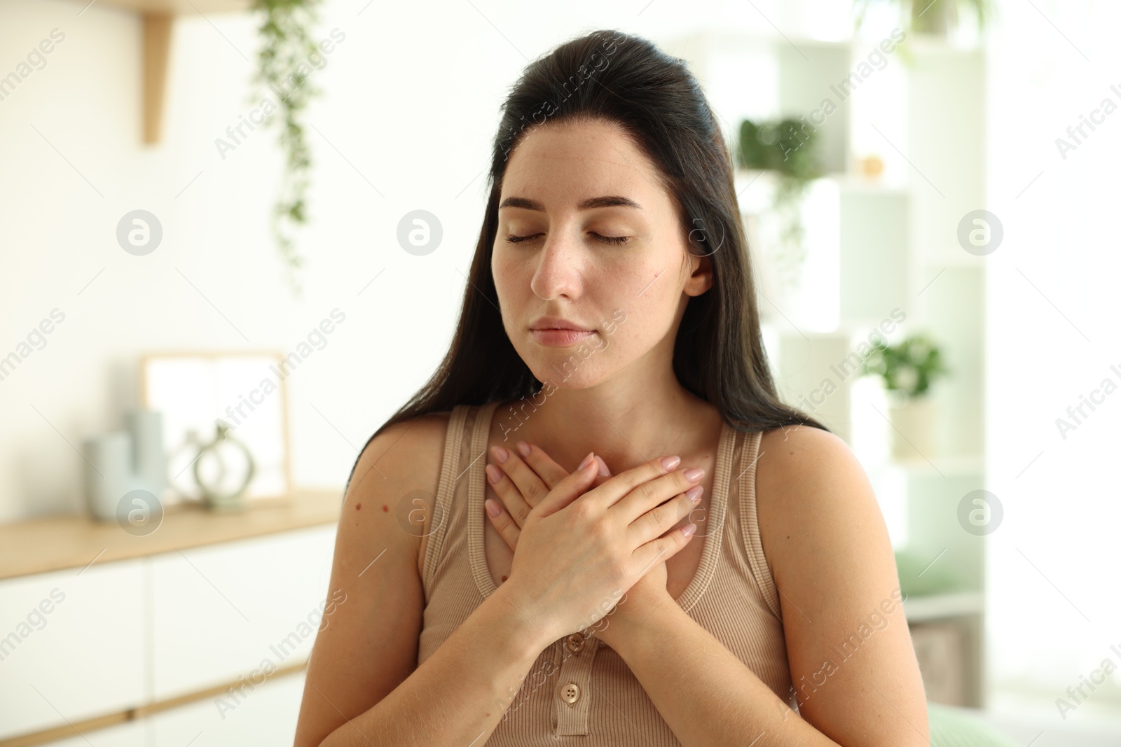Panic attack. Woman breathing to calm down at home, space for text Photo of Panic attack. Woman breathing to calm down at home, space for text