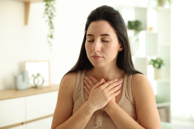 Photo of Panic attack. Woman breathing to calm down at home, space for text