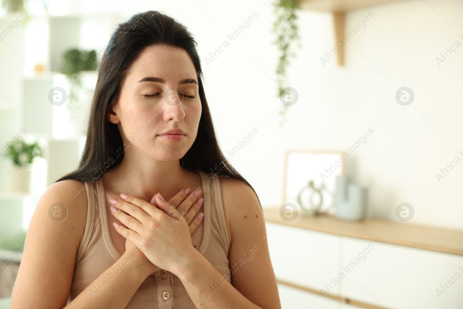 Panic attack. Woman breathing to calm down at home, space for text Photo of Panic attack. Woman breathing to calm down at home, space for text