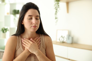 Photo of Panic attack. Woman breathing to calm down at home, space for text