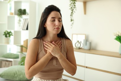 Photo of Panic attack. Woman breathing to calm down at home, space for text