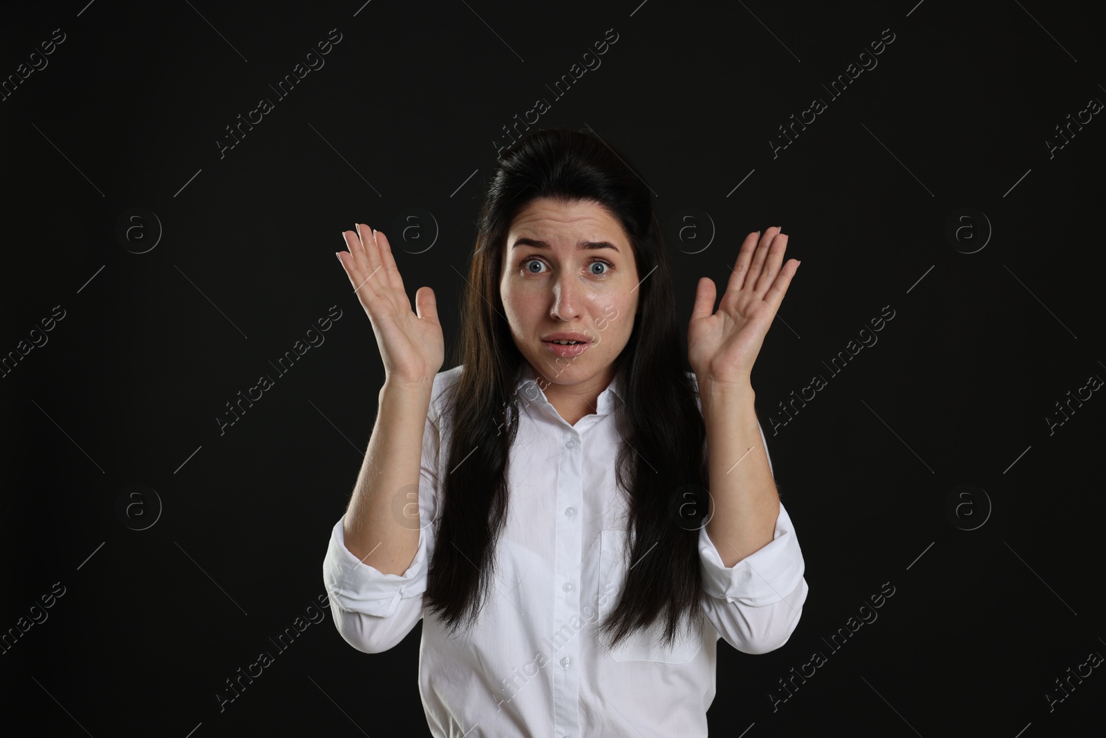 Woman suffering from panic attack on black background Photo of Woman suffering from panic attack on black background