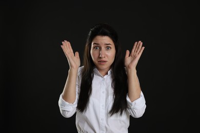 Photo of Woman suffering from panic attack on black background