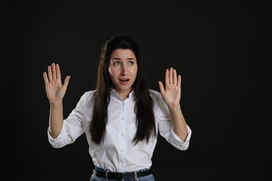 Photo of Woman suffering from panic attack on black background