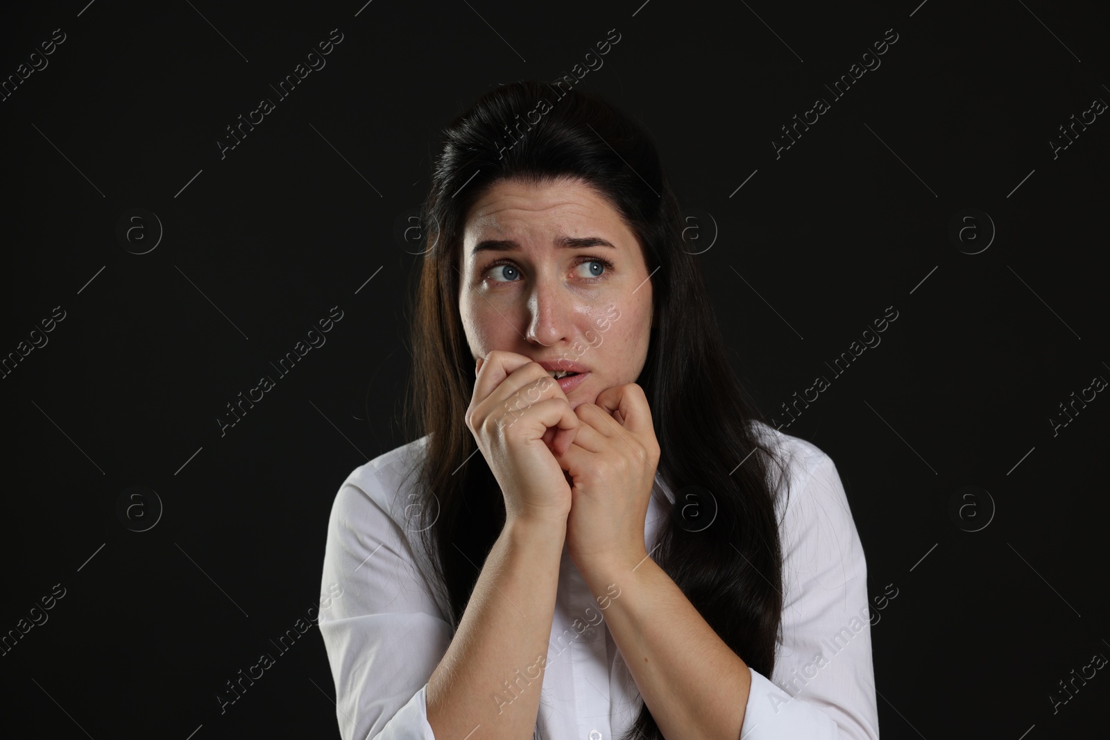 Photo of Woman suffering from panic attack on black background