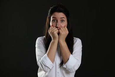 Photo of Woman suffering from panic attack on black background