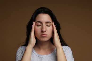 Photo of Panic attack. Woman calm herself down on brown background