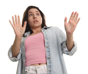 Photo of Worried woman suffering from panic attack on white background, low angle view