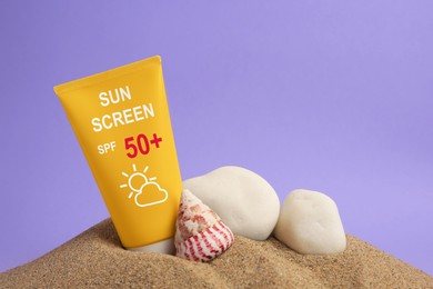 Image of Sunscreen in tube, stones and seashell on sand against lilac background. Sun protection product