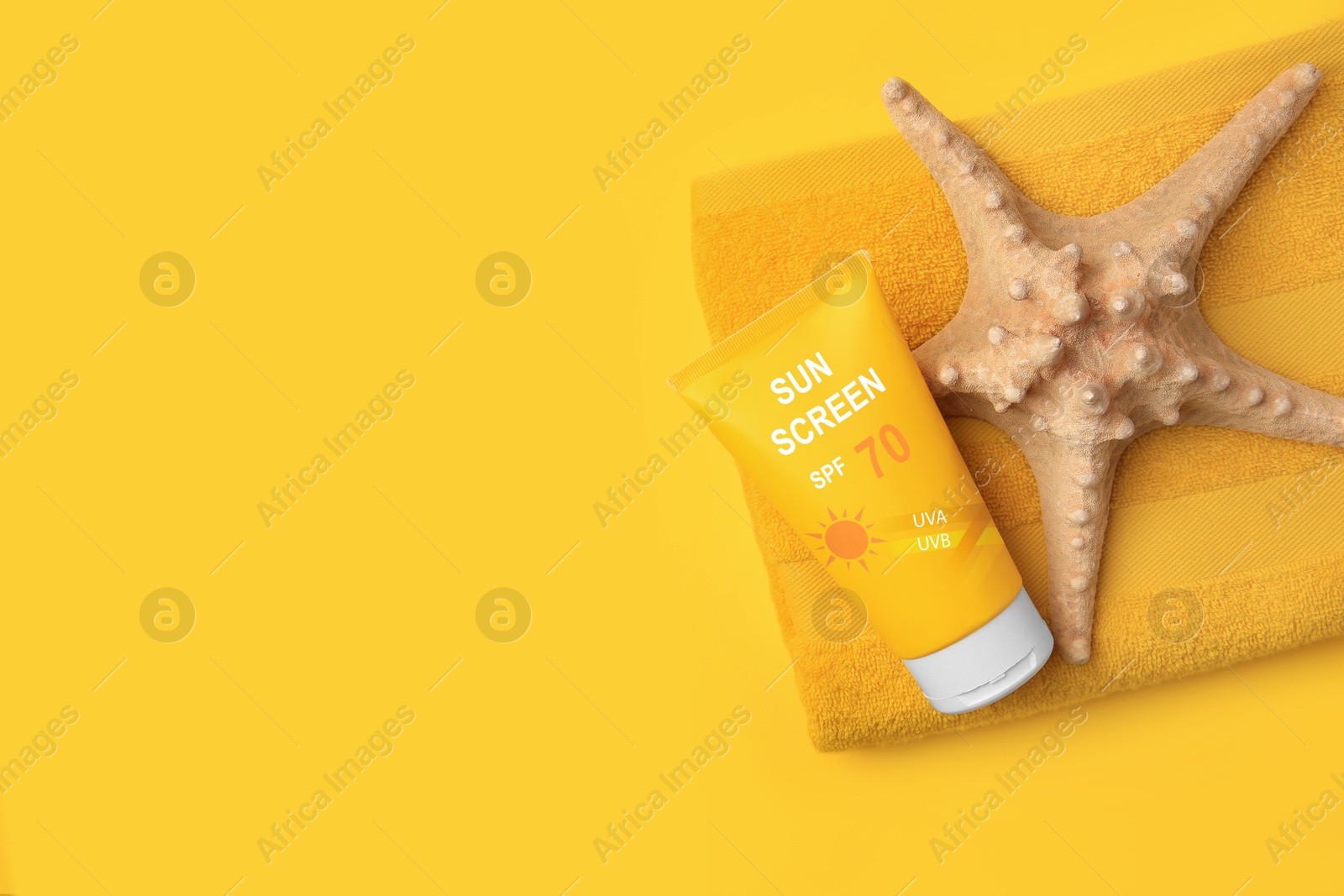 Sunscreen in tube, starfish and beach towel on orange background, top view. Sun protection product Image of Sunscreen in tube, starfish and beach towel on orange background, top view. Sun protection product