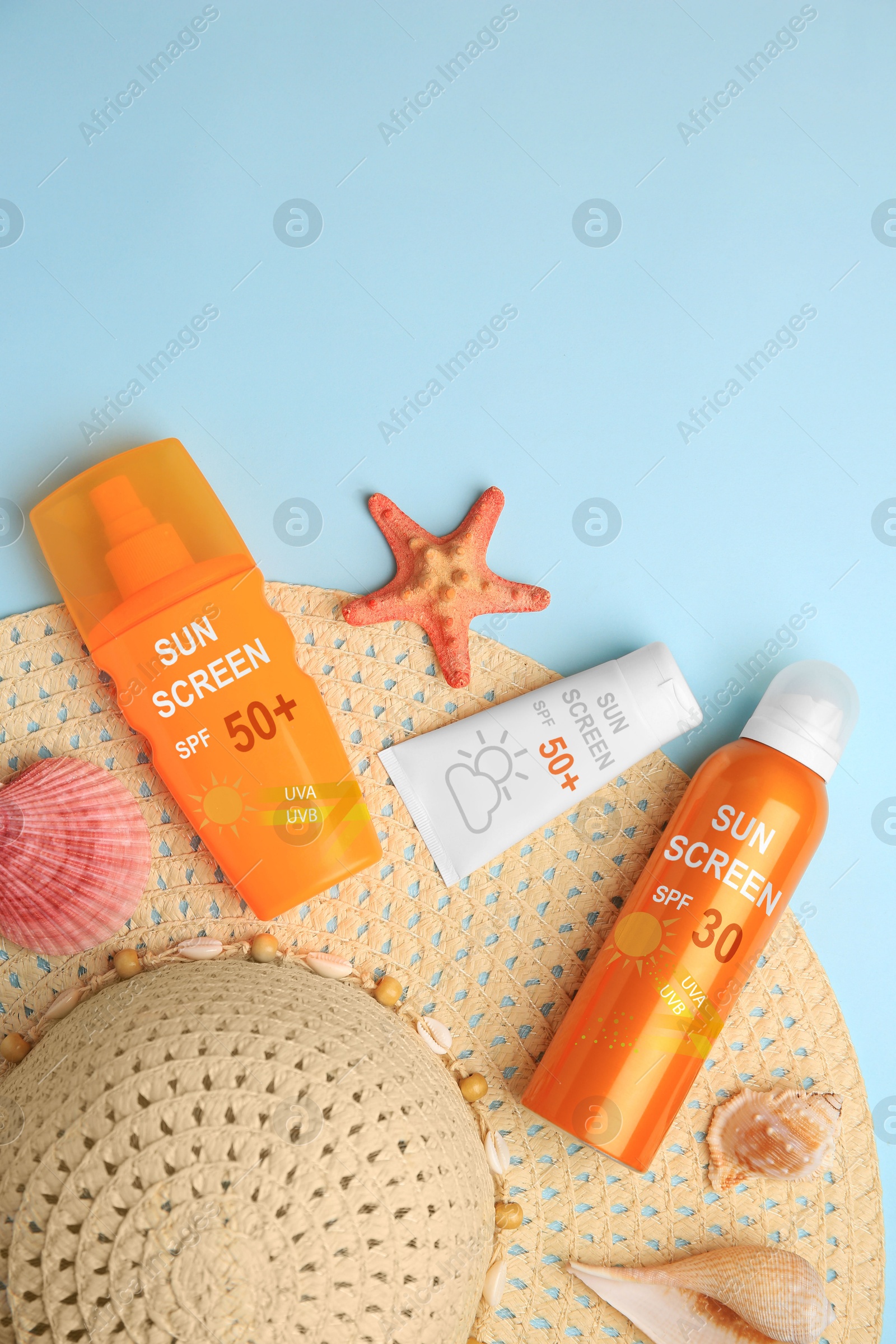 Sunscreens and hat on light blue background, top view. Sun protection product Image of Sunscreens and hat on light blue background, top view. Sun protection product