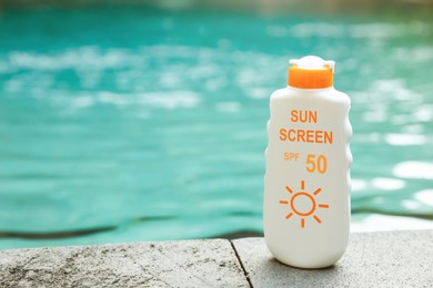 Image of Sunscreen in bottle on swimming pool edge. Sun protection product