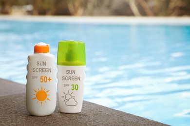 Image of Sunscreens in bottles on swimming pool edge. Sun protection product