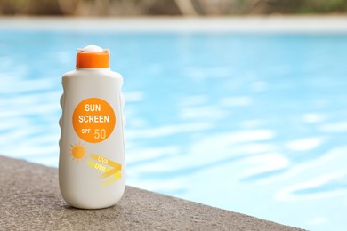 Image of Sunscreen in bottle on swimming pool edge. Sun protection product