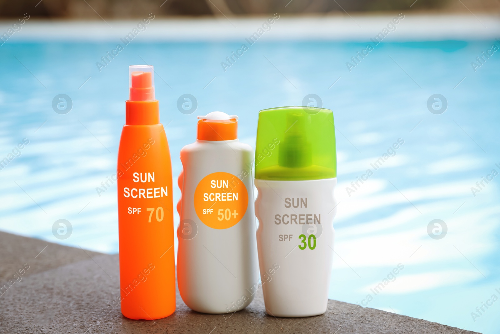 Sunscreens in bottles on swimming pool edge. Sun protection product Image of Sunscreens in bottles on swimming pool edge. Sun protection product