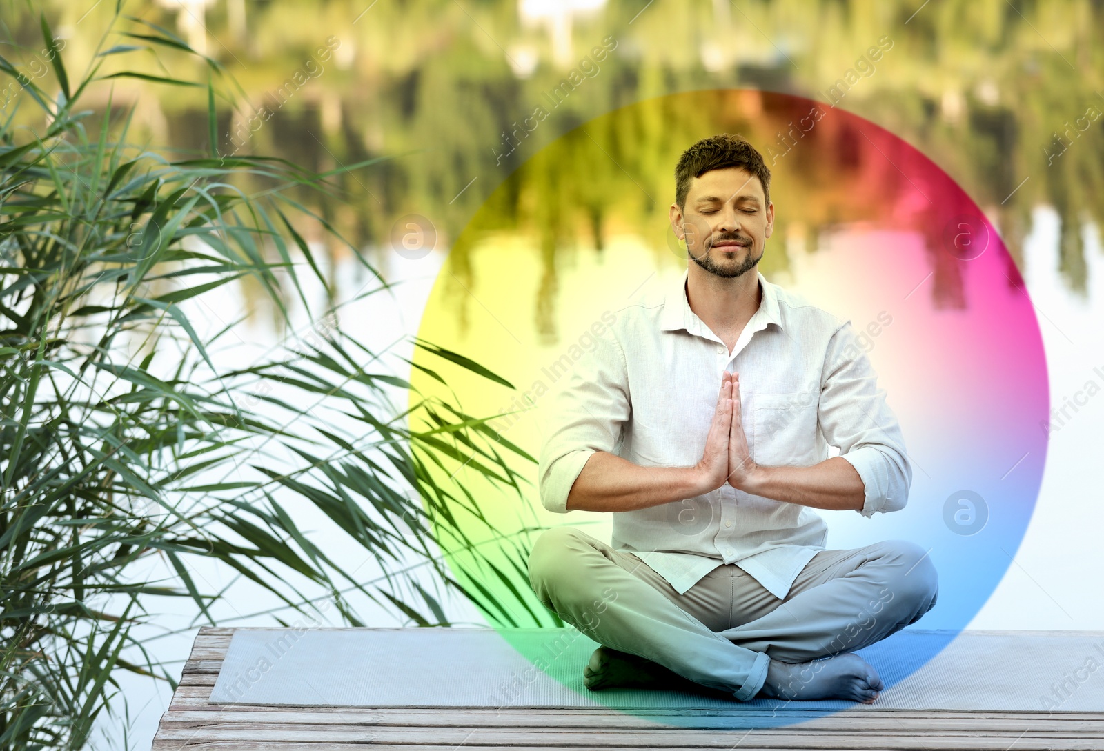 Man meditating in Lotus pose on pier near river. Rainbow bubble around him representing aura Image of Man meditating in Lotus pose on pier near river. Rainbow bubble around him representing aura