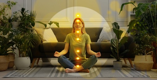 Image of Woman meditating in Lotus pose at home. Bubble around her symbolizing aura and glowing lights representing chakras