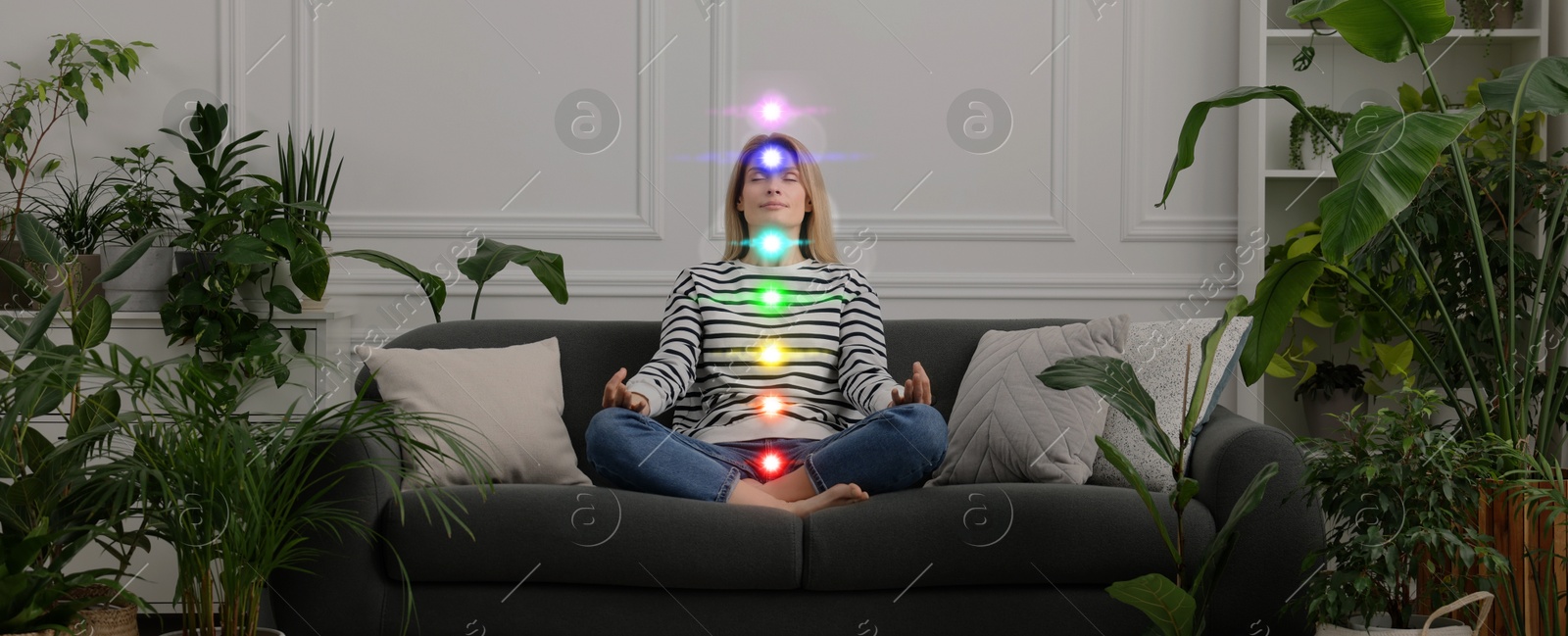 Woman meditating in Lotus pose at home. Rainbow lights representing chakras Image of Woman meditating in Lotus pose at home. Rainbow lights representing chakras