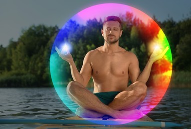 Image of Man meditating in Lotus pose on SUP board. Rainbow bubble around him representing aura