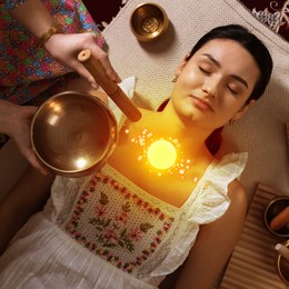 Image of Woman meditating during singing bowl therapy, top view. Glowing bubble representing chakra