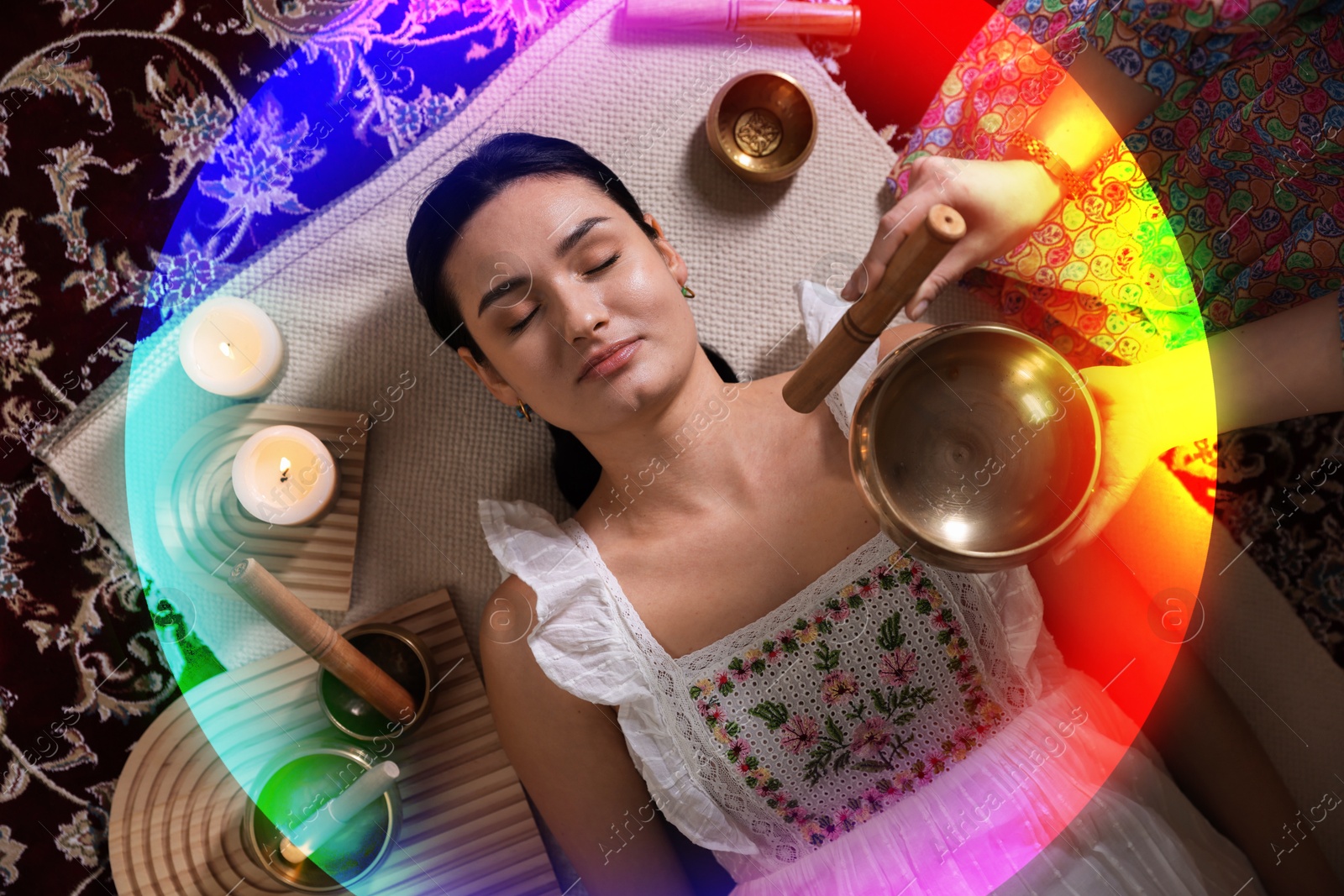 Image of Woman meditating during singing bowl therapy, top view. Rainbow bubble around her representing aura
