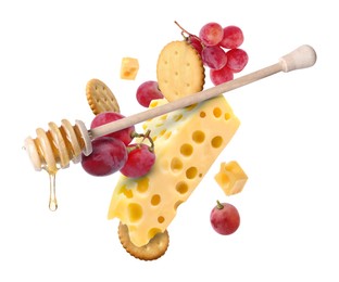 Image of Cheese, grapes, crackers and honey in air on white background. Tasty appetizers for cheese board