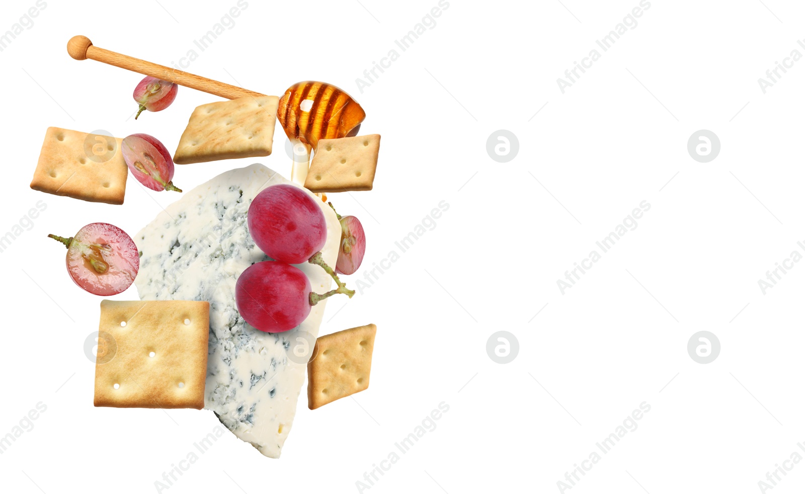 Image of Cheese, grapes, crackers and honey in air on white background. Tasty appetizers for cheese board