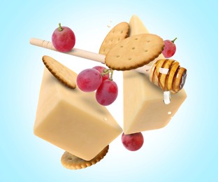 Image of Cheese, grapes, crackers and honey in air on light blue background. Tasty appetizers for cheese board