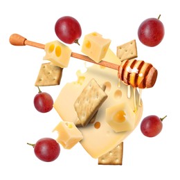Image of Cheese, grapes, crackers and honey in air on white background. Tasty appetizers for cheese board