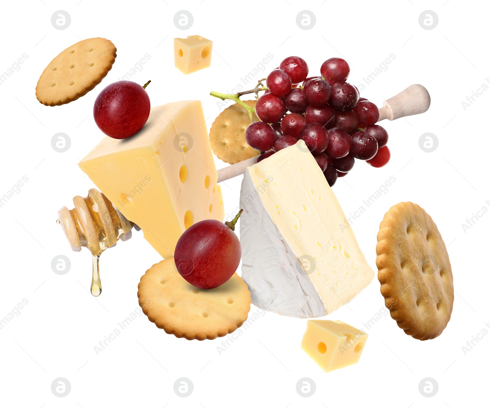 Cheese board products in air on white background. Different types of cheese, grapes, crackers and honey Image of Cheese board products in air on white background. Different types of cheese, grapes, crackers and honey