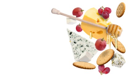Image of Cheese board products in air on white background. Different types of cheese, grapes, crackers and honey