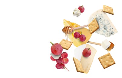 Image of Cheese board products in air on white background. Different types of cheese, grapes, crackers and honey