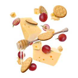 Image of Cheese, grapes, crackers and honey in air on white background. Tasty appetizers for cheese board
