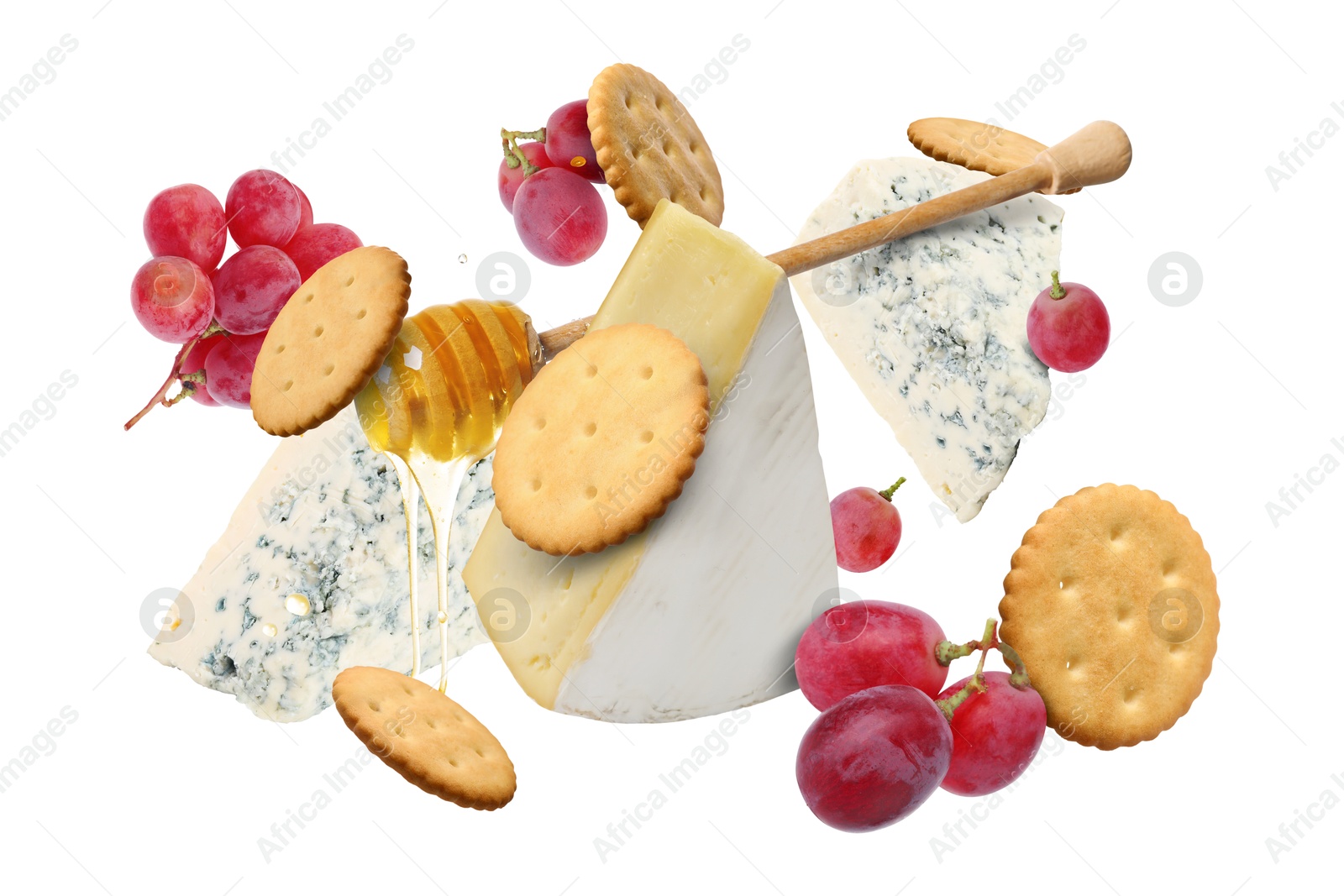 Image of Cheese board products in air on white background. Different types of cheese, grapes, crackers and honey