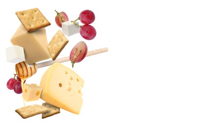 Image of Cheese board products in air on white background. Different types of cheese, grapes, crackers and honey