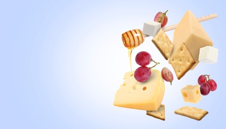 Image of Cheese board products in air on blue gradient background. Different types of cheese, grapes, crackers and honey