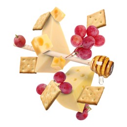 Image of Cheese board products in air on white background. Different types of cheese, grapes, crackers and honey