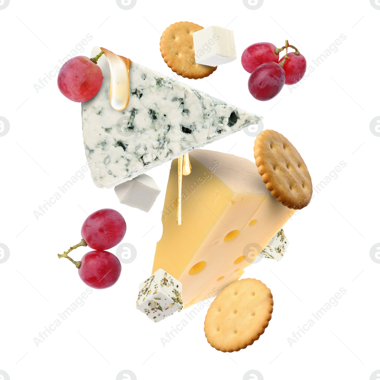 Cheese board products in air on white background. Different types of cheese, grapes, crackers and honey Image of Cheese board products in air on white background. Different types of cheese, grapes, crackers and honey
