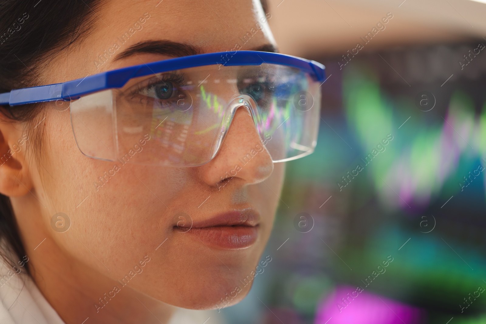 Young woman wearing glasses with reflection on blurred background, closeup Photo of Young woman wearing glasses with reflection on blurred background, closeup