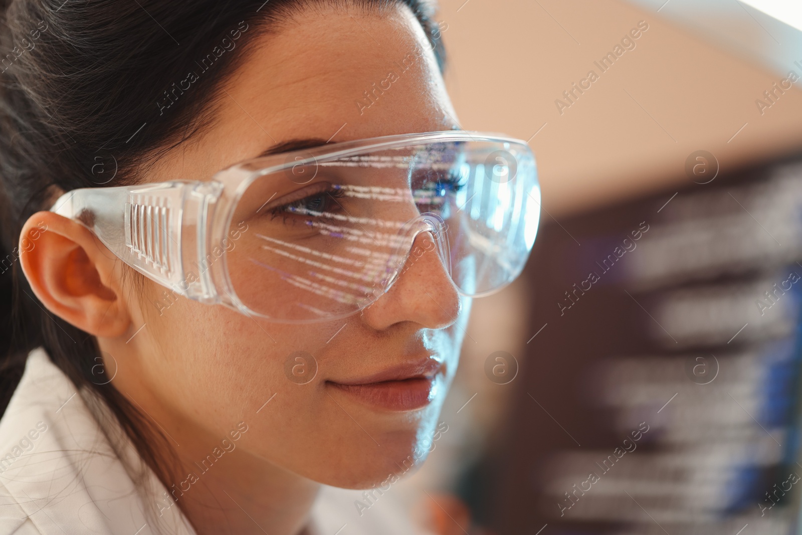 Young woman wearing glasses with reflection on blurred background, closeup Photo of Young woman wearing glasses with reflection on blurred background, closeup