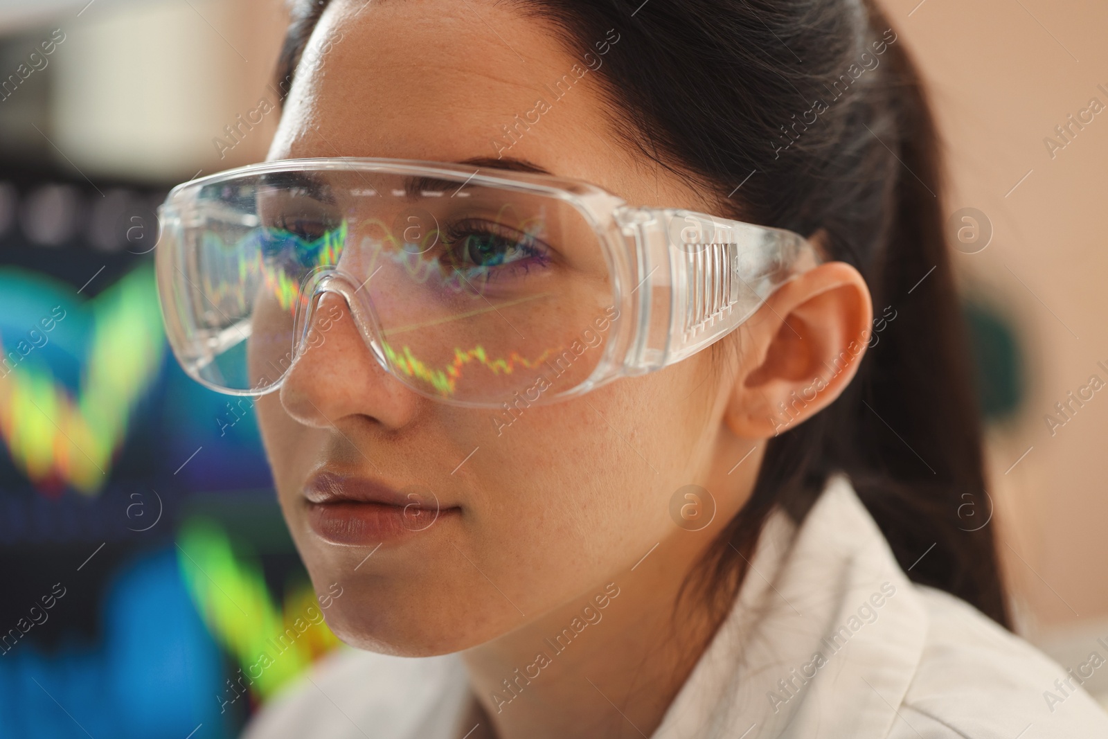 Photo of Young woman wearing glasses with reflection on blurred background, closeup