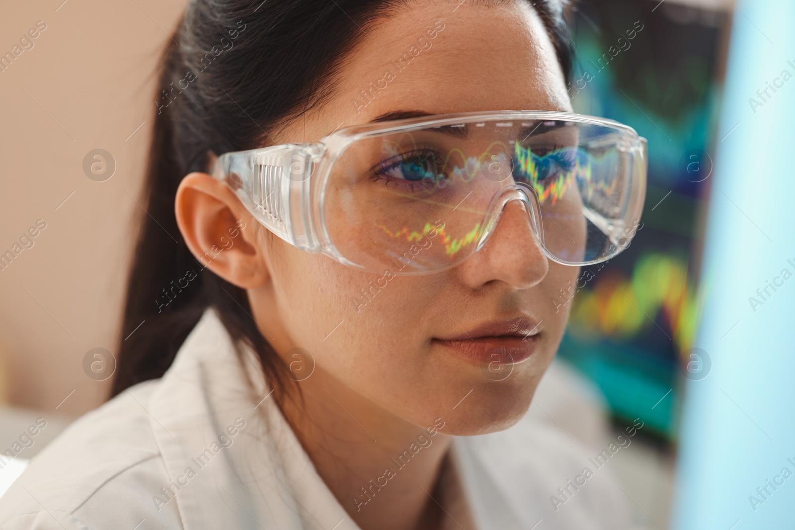 Young woman wearing glasses with reflection on blurred background, closeup Photo of Young woman wearing glasses with reflection on blurred background, closeup