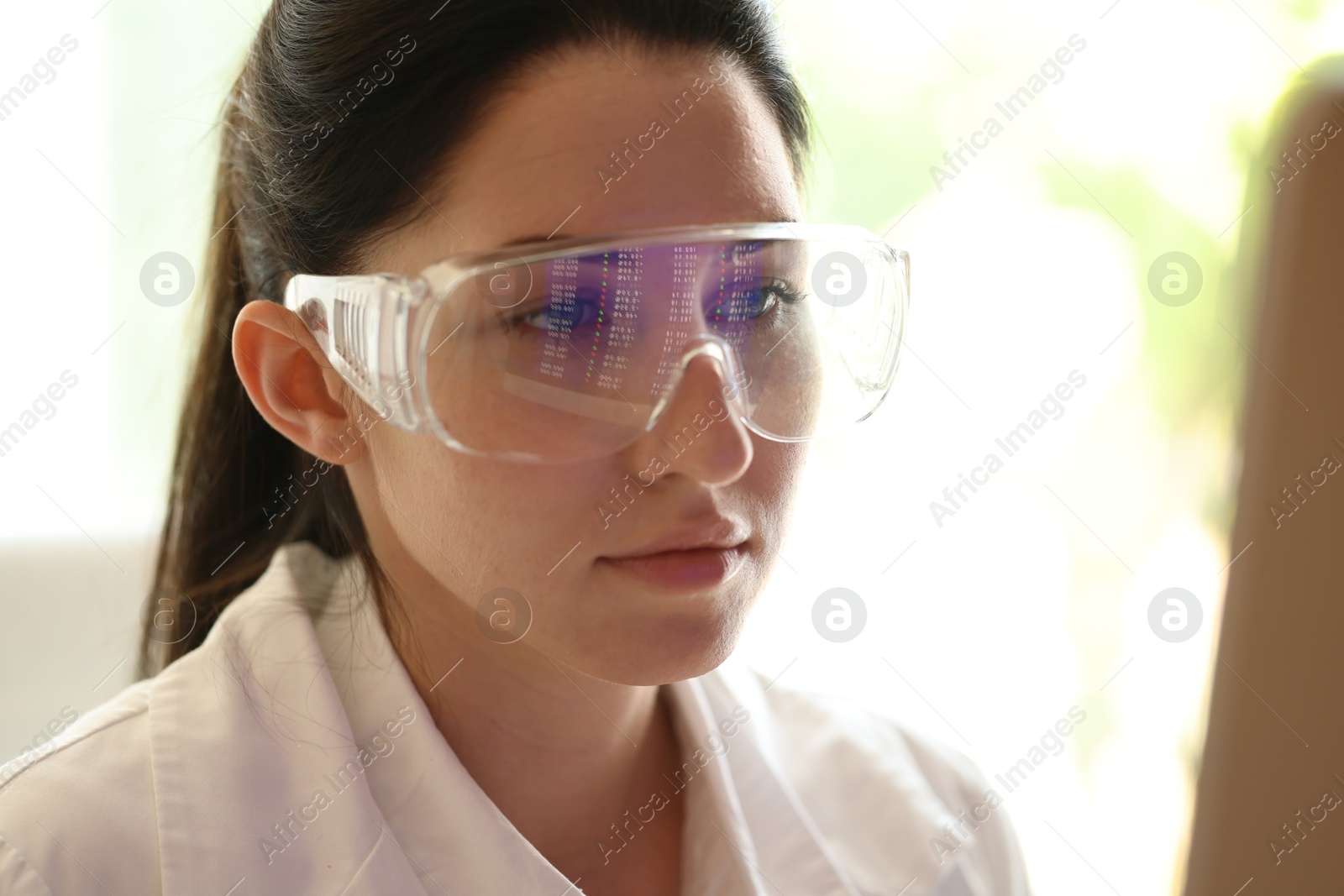 Young woman wearing glasses with reflection indoors, closeup Photo of Young woman wearing glasses with reflection indoors, closeup