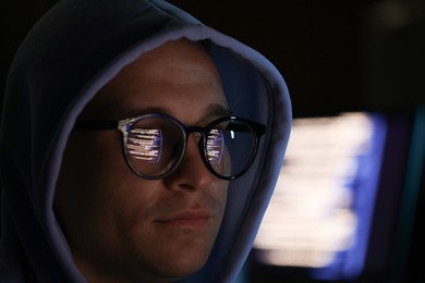 Photo of Young man wearing glasses with reflection on blurred background, closeup