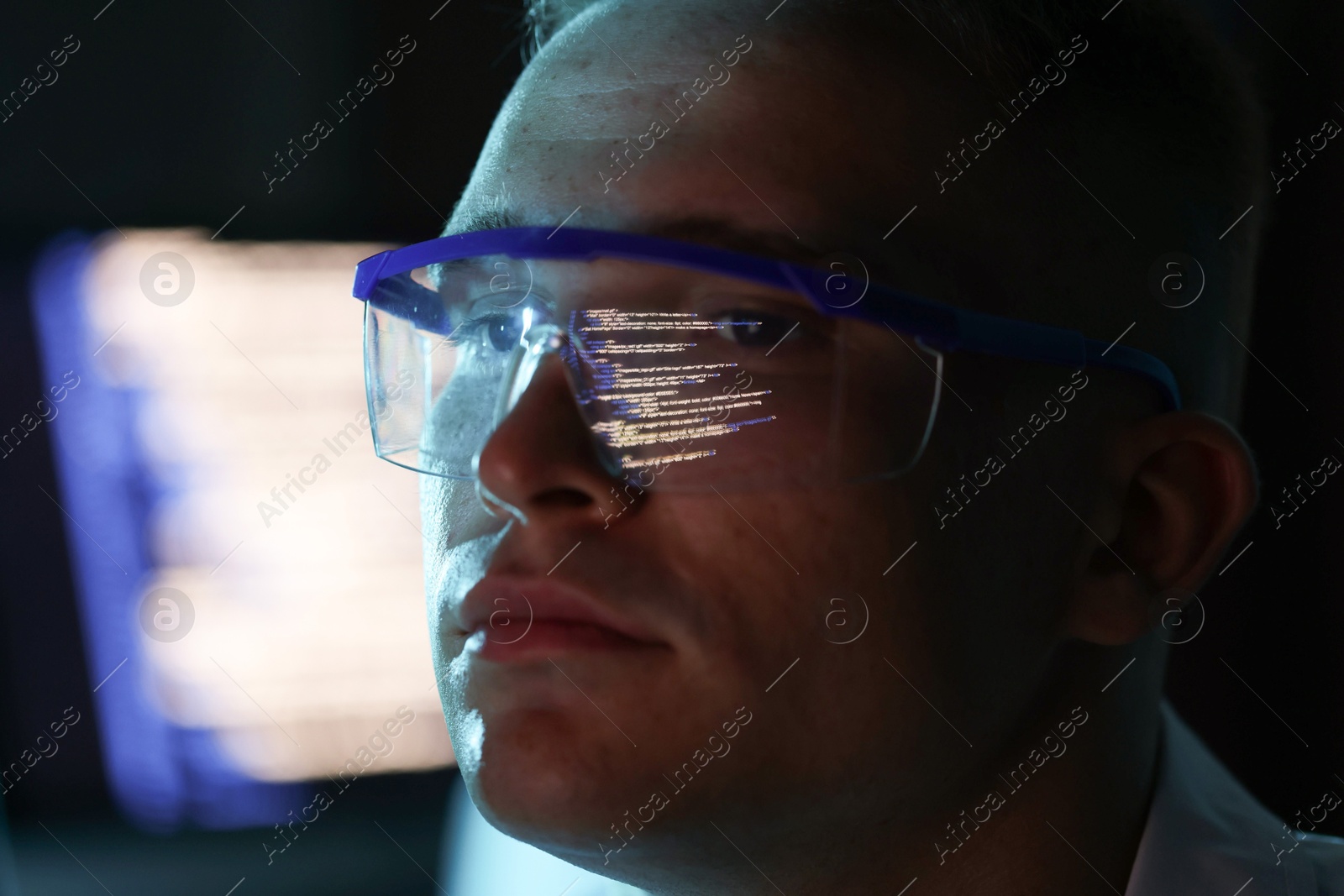 Young man wearing glasses with reflection on blurred background, closeup Photo of Young man wearing glasses with reflection on blurred background, closeup