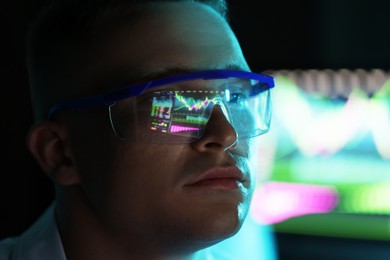 Photo of Young man wearing glasses with reflection on blurred background, closeup
