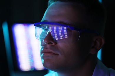 Photo of Young man wearing glasses with reflection on blurred background, closeup