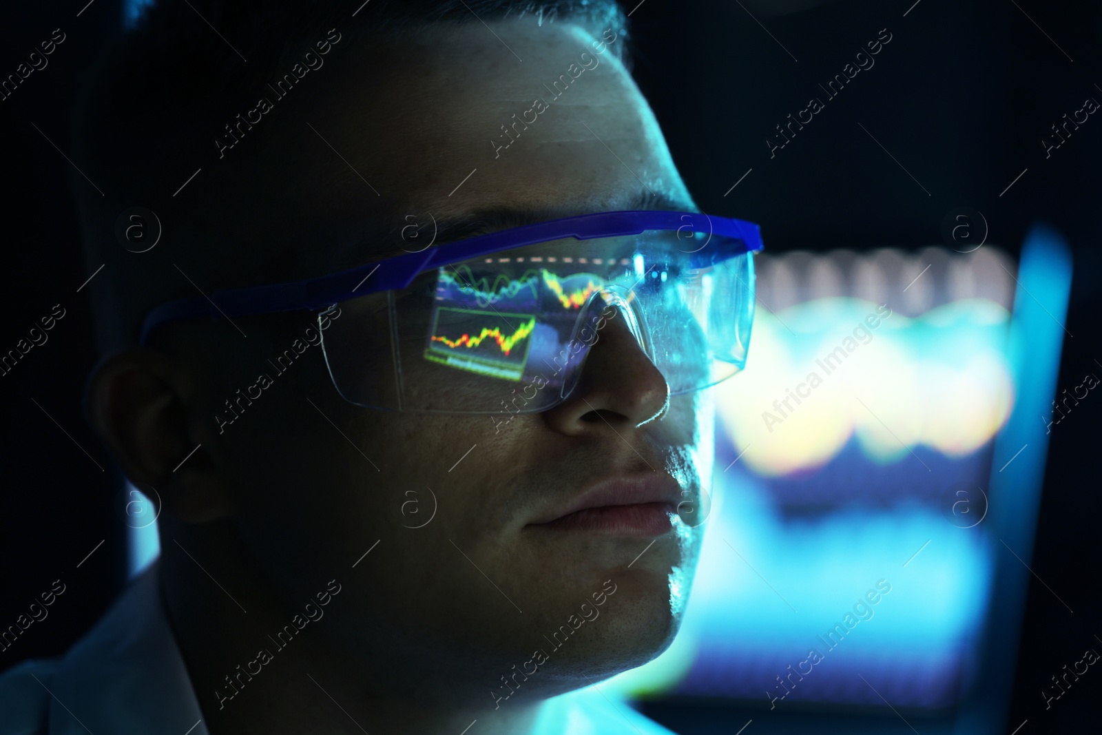 Young man wearing glasses with reflection on blurred background, closeup Photo of Young man wearing glasses with reflection on blurred background, closeup