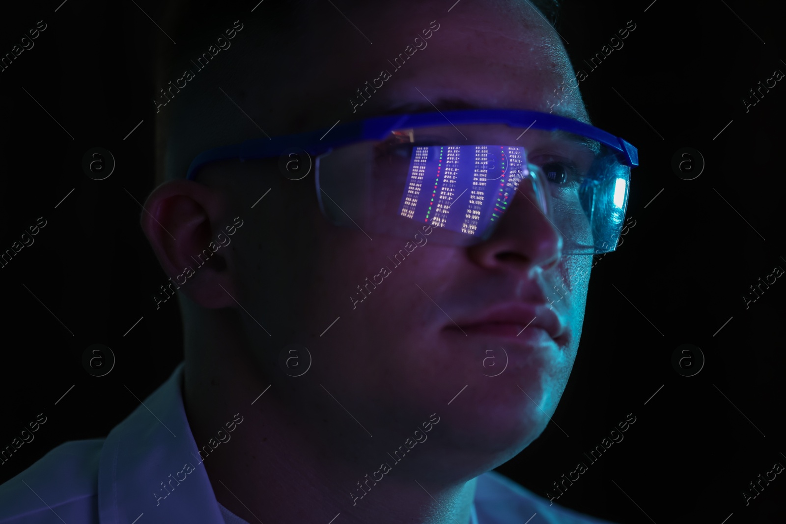 Young man wearing glasses with reflection on dark background, closeup Photo of Young man wearing glasses with reflection on dark background, closeup